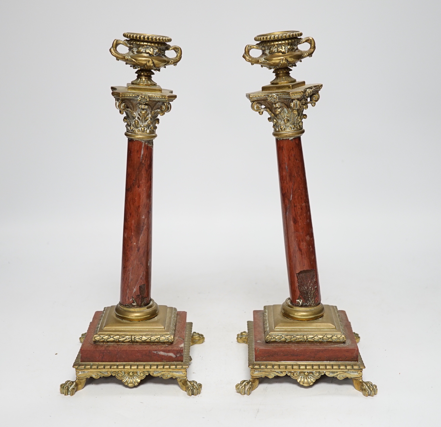 A pair of 19th century brass mounted rouge marble candlesticks, 29cm (a.f.)